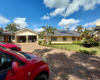 This charming single-story home features a neatly manicured front garden and an expansive brick-paved driveway with ample parking. The main house boasts a warm yellow façade, large windows, and an eco-friendly solar water heating system on the roof. An attached double garage provides spacious storage or parking space. Surrounded by palm trees and lush green hedges, this property offers excellent curb appeal under a beautiful, open sky. This charming single-story home features a neatly manicured front garden and an expansive brick-paved driveway with ample parking. The main house boasts a warm yellow façade, large windows, and an eco-friendly solar water heating system on the roof. An attached double garage provides spacious storage or parking space. Surrounded by palm trees and lush green hedges, this property offers excellent curb appeal under a beautiful, open sky.